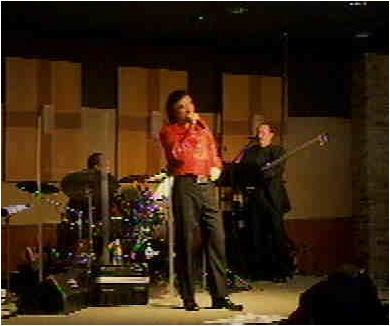 Neil Diamond impersonator on stage with band 2008